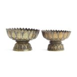 Two 19th century Thai niello gilded silver footed bowls of lotus form, each with petal shaped rims