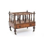 A 19th century mahogany three division Canterbury, turned supports, with single drawer, on ceramic