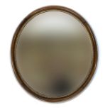 A 19th century oval wall mirror, in a deep walnut frame, with gilt bobble moulded slip, 66cm wide,
