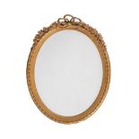 A Victorian giltwood and composition wall mirror, c.1870, with tied ribbon and floral swag cresting,
