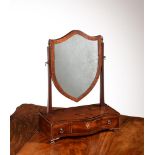 A George III mahogany and inlaid dressing mirror, c.1780, the platform of serpentine outline and