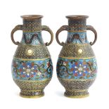 A pair of Japanese brass and champleve enamel twin handled vases, 18.5cm high