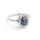 An early 20th century platinum, sapphire and diamond cluster ring, the sapphire approx. 1.2ct,