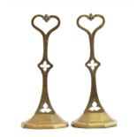 A pair of late Victorian brass doorstops with trefoil and quatrefoil cutouts and heart shaped