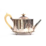 A George III silver teapot on stand, London 1783, of shaped oval straight sided form, with ivory