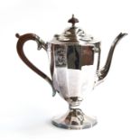 A silver teapot by A Marston & Co, Birmingham 1938, of twelve sided form with scrolling wooden