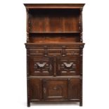 An oak court cupboard, later top over a base with geometric mouldings, 117cm wide, 50cm deep,