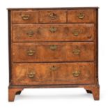 A largely 18th century walnut chest of drawers, the later pine top over three short and three