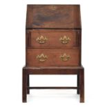 An 18th century and later bureau, the fall front opening to a fitted interior, over two drawers,