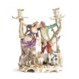 A 19th century Meissen style porcelain figure group candle holder in the form of a continental