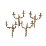 A set of four early 20th century gilt metal twin arm wall appliques in Louis XV style, 33cm wide,