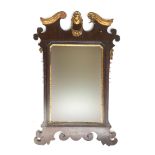 An 18th century fret carved wall mirror, with gilt carved bust of a lady cresting, a swag of fruit