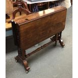 A large Victorian rosewood sutherland table, pierced scrolling end supports, on brass casters, 90cmL