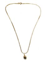 An 18ct gold necklace with a floral sapphire and diamond set pendant, the chain 39cm long unclasped,