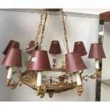 An eight arm gilt metal chandelier, each fitting on a swan form candle style sconce, with tole