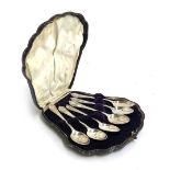 A set of six late Victorian plated teaspoons, within a fitted scallop shell leather case, with