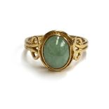 A 9ct gold and jade cabochon ring with Celtic style shoulders, size N, 3.3g