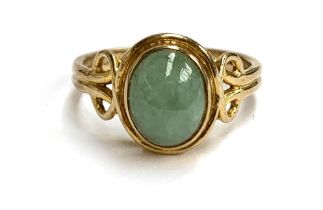 A 9ct gold and jade cabochon ring with Celtic style shoulders, size N, 3.3g