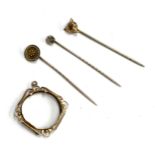 A 15ct gold stick pin, 1.4g; together with a 9ct sovereign mount, 1.6g; a fox mask stick pin and one