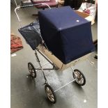 A Silver Cross vintage dolls pram, with fitted blankets, eiderdown, raincover and pillow