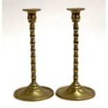 A pair of early 20th century brass candlesticks, removeable nozzles, 33cmH