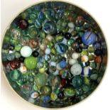 A tin containing a quantity of glass marbles