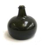 An antique green glass onion bottle, likely 18th century, 14cmH