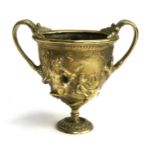 A heavy 19th century Grand Tour gilt bronze replica Roman kantharos cup, decorated in relief with