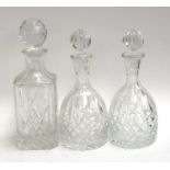 A pair of glass decanters, 24cmH; together with one other 27cmH