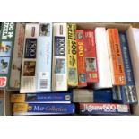 A box containing approx. 14 jigsaw puzzles