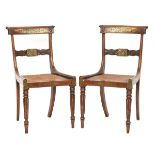 A pair of Regency beech and brass inlaid dining chairs, with cane seats