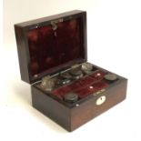 A 19th century rosewood vanity/writing box, the fitted interior with inkwells and other pots, the