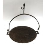 An iron griddle, 49cmD, with a possibly associated hoop