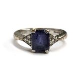 A 9ct white gold ring set with an emerald cut iolite with three small diamonds either side, 3.6g,