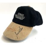 A Cisco World Match Play Championship cap bearing the autographs of Padraig Harrington and two