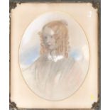 A 19th century portrait of a girl, coloured chalk on paper, signed and dated 1857, in an oval mount,