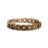 An Art Deco 9ct gold eternity ring, some paste missing, size Q, 2g