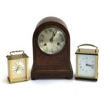 A domed oak mantel clock; together with two modern carriage clocks