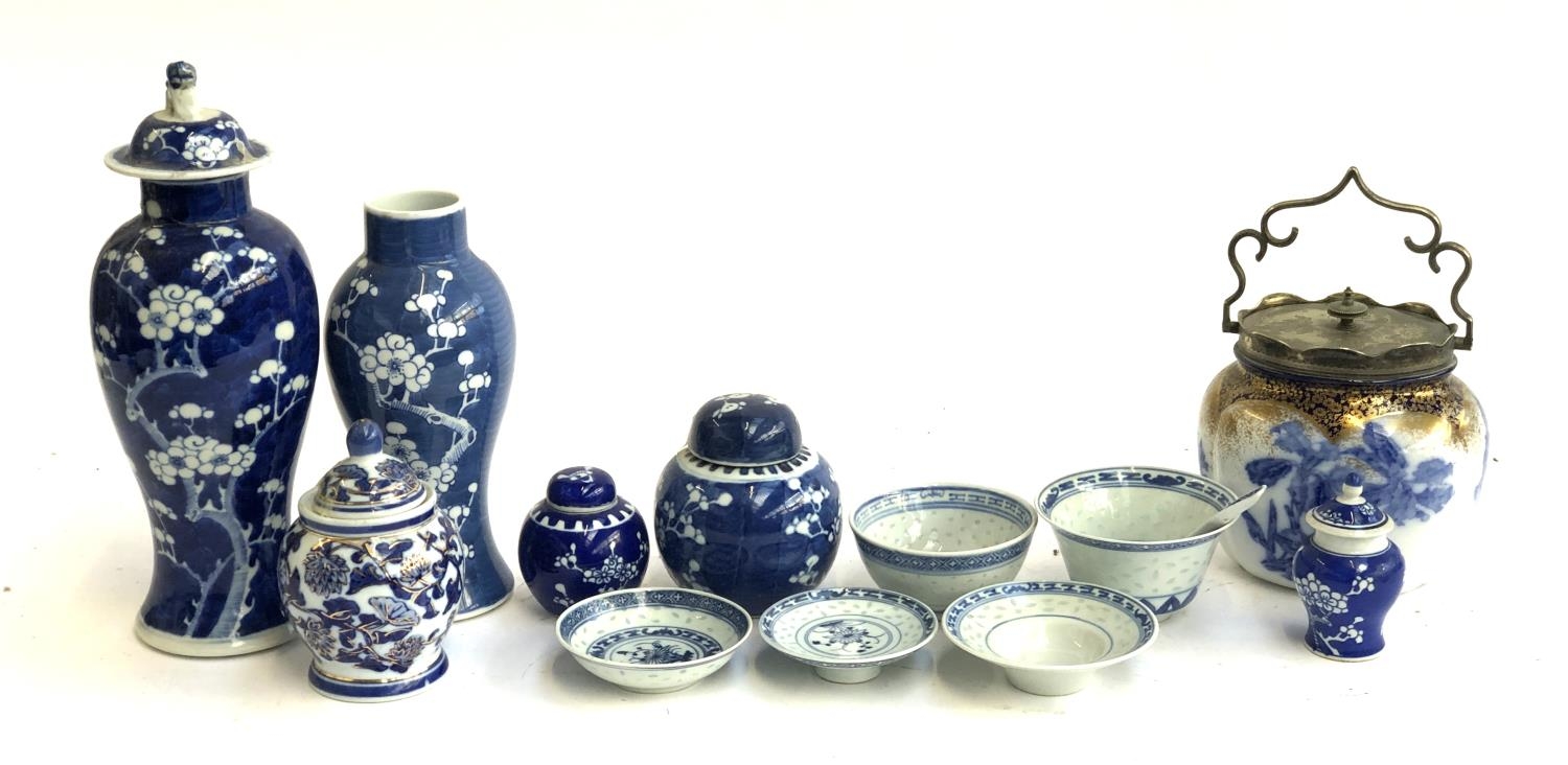 A mixed lot of blue and white ceramics to include Chinese rice ware; prunus vases; Doulton biscuit