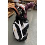 A Powakaddy golf bag containing a quantity of clubs to include PGA; Wilson etc