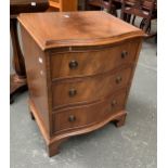 A reproduction serpentine bedside chest of three drawers, 53x40x67cmH