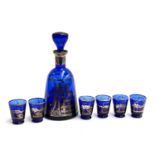 A Bohemian cobalt blue glass schnapps set, the gilt decorated decanter depicting a courting scene,