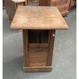 An unusual Arts and Crafts style oak pedestal table,, the over-jutting top on a tapering base with