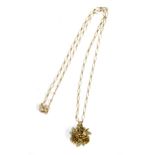 A 9ct gold chain, approx. 1.8g, with a floral gilt metal pendant