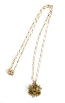 A 9ct gold chain, approx. 1.8g, with a floral gilt metal pendant