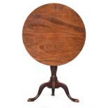 A George III mahogany tripod table, the tip-top on a vase turned column and cabriole legs with