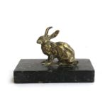 A brass figure of a hair, mounted on a marble base, the hare 7cmH, the base 14cmL