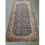A large Persian rug, approx. 329x154cm