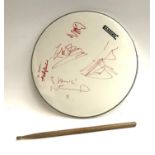 A drum skin bearing the autographs of Oasis band members Noel and Liam Gallagher, Andy Bell, Zak