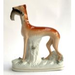 A Staffordshire figure of a greyhound and quarry, encrusted detail to base, 27.5cmH